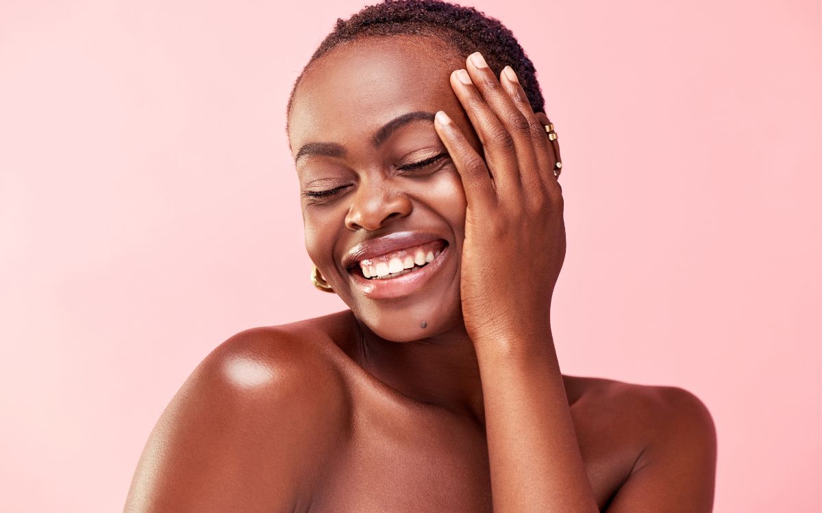 Smiling woman against a pink background