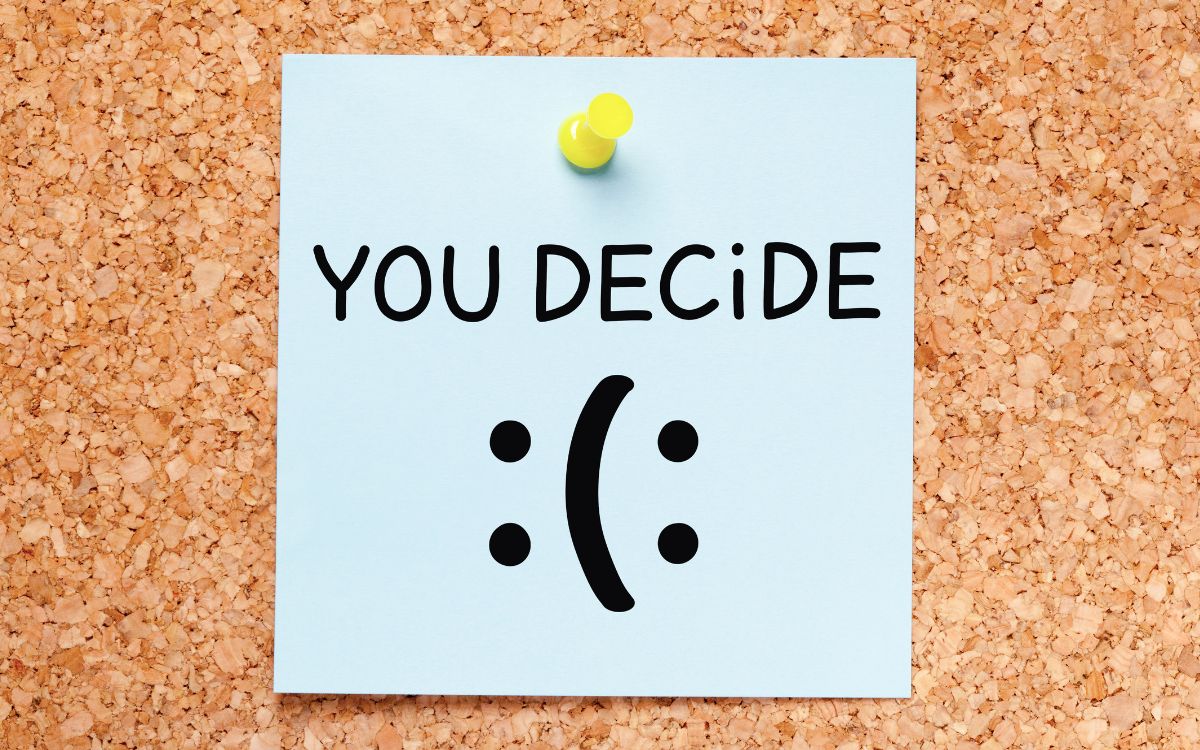 A note reading You Decide with a choice between a happy and sad face