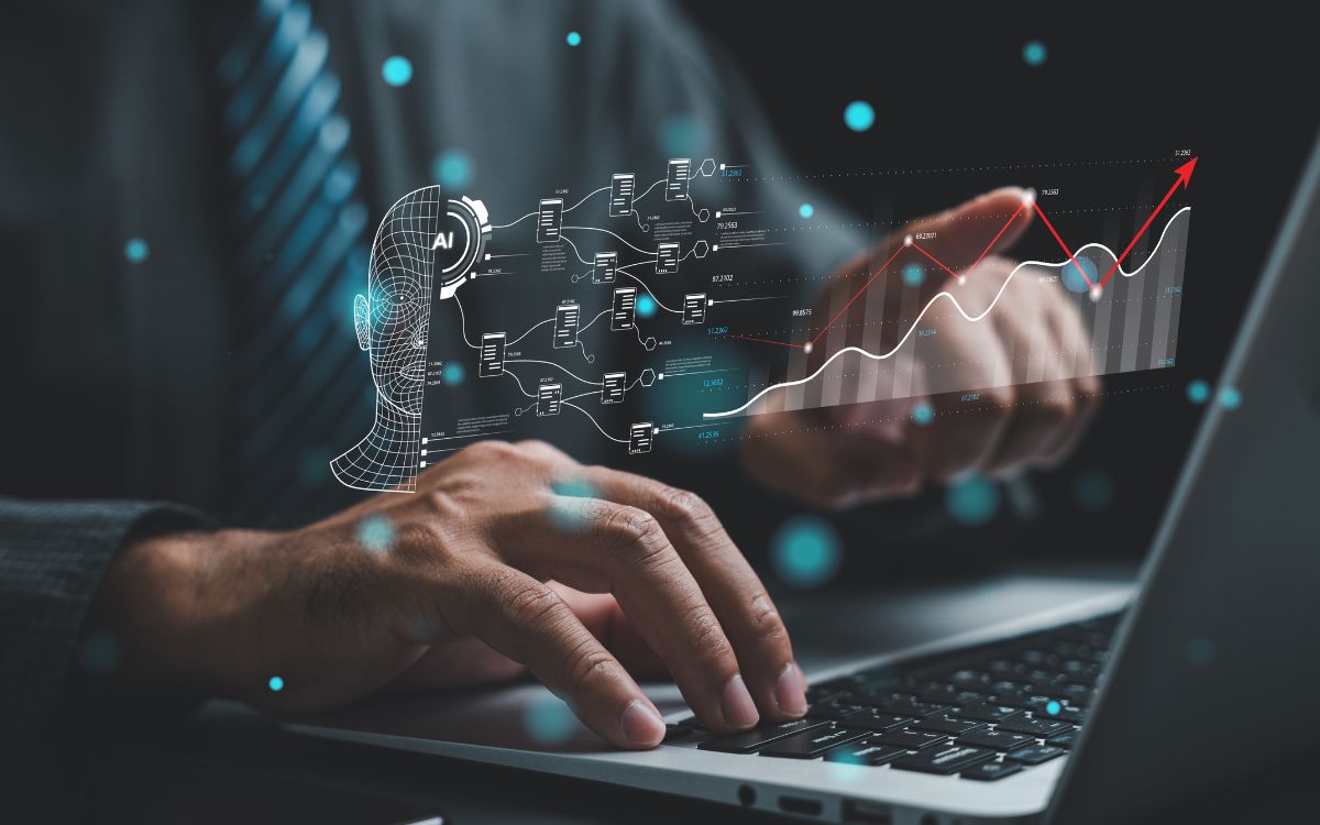 Person using a laptop with AI workflow and performance graphics